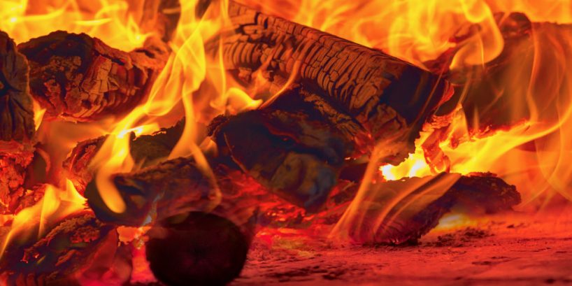 Image of a brick pizza oven with fire and flame