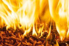 Closeup of burning wood pellets in oven.